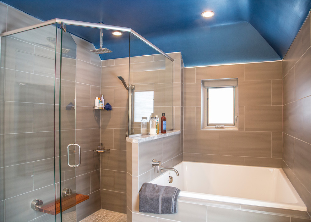 This is an example of a mid-sized contemporary master bathroom in Detroit with flat-panel cabinets, dark wood cabinets, a japanese tub, a corner shower, a one-piece toilet, gray tile, porcelain tile, porcelain floors, an undermount sink, solid surface benchtops, grey floor, a hinged shower door and grey walls.