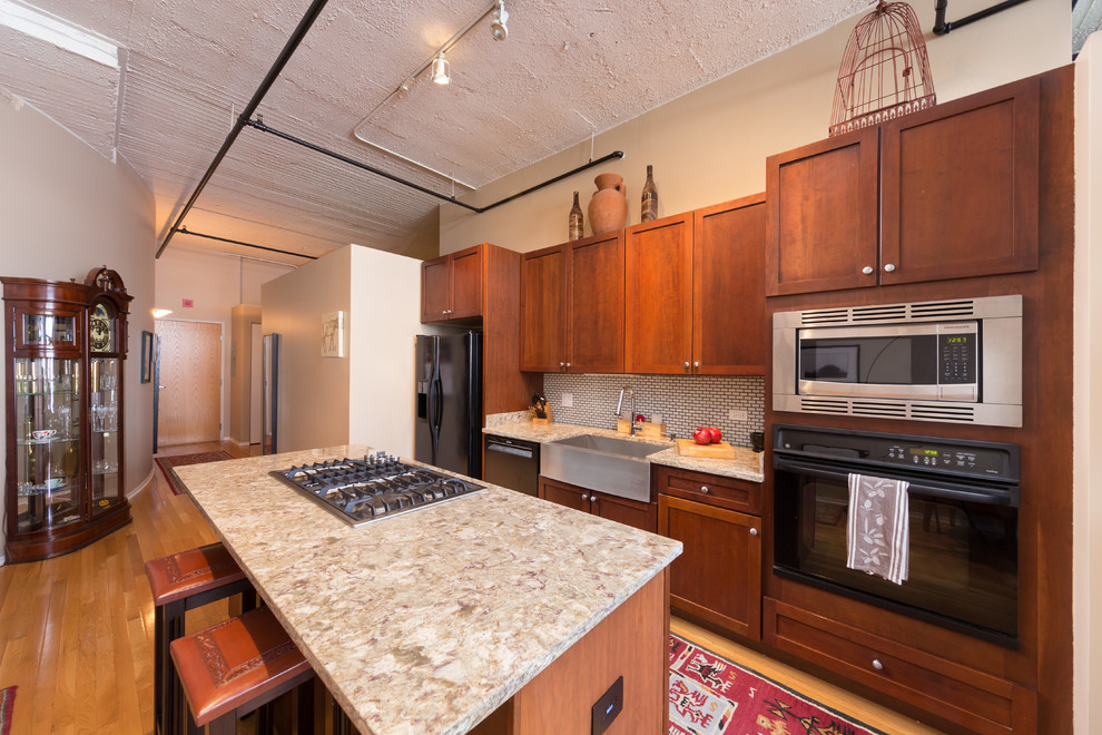 Enclosed kitchen - mid-sized contemporary galley light wood floor enclosed kitchen idea in Chicago with an undermount sink, flat-panel cabinets, medium tone wood cabinets, granite countertops, cement tile backsplash, stainless steel appliances and an island