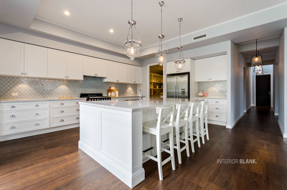 Design ideas for a large beach style l-shaped kitchen pantry in Gold Coast - Tweed with an undermount sink, recessed-panel cabinets, white cabinets, quartz benchtops, blue splashback, porcelain splashback, black appliances, vinyl floors and with island.