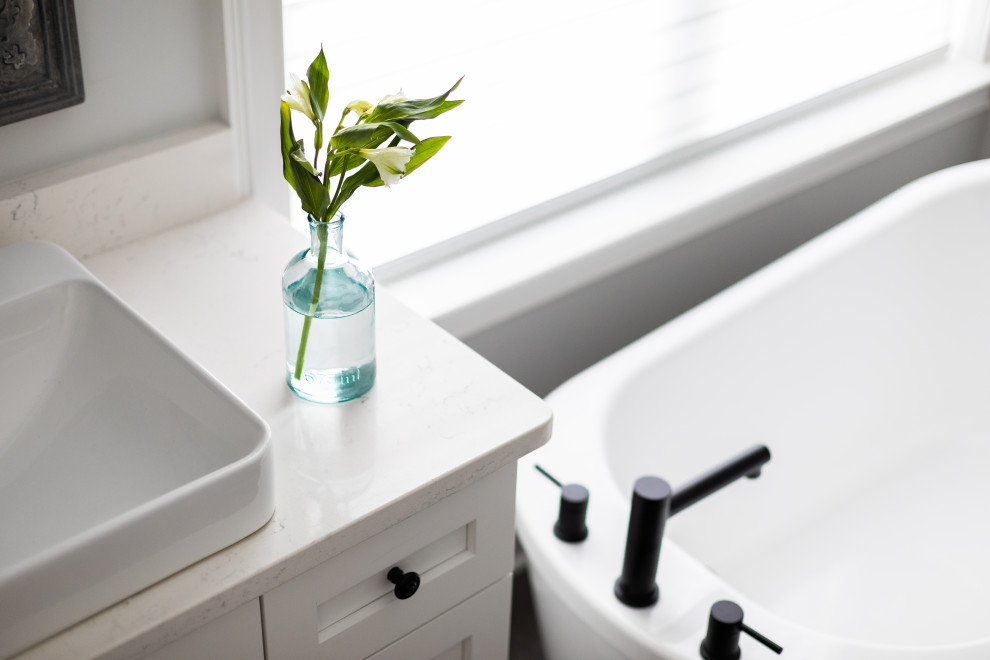 Inspiration for a transitional master white tile porcelain tile, gray floor and single-sink freestanding bathtub remodel with shaker cabinets, white cabinets, white walls, a vessel sink, quartz countertops, white countertops and a freestanding vanity