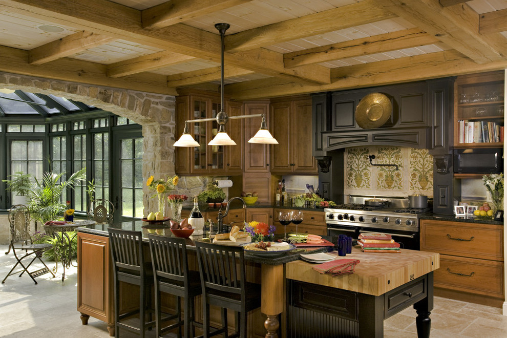 Inspiration for a large country eat-in kitchen in Chicago with raised-panel cabinets, medium wood cabinets, multi-coloured splashback, stainless steel appliances, travertine floors, with island and brown floor.