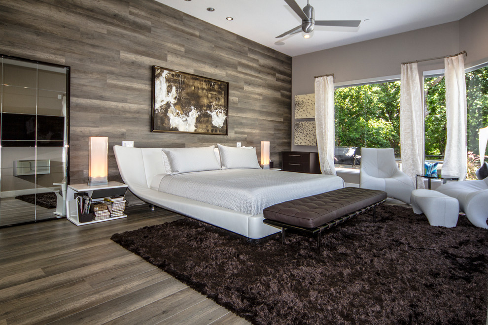 Large contemporary master bedroom in Dallas with grey walls, dark hardwood floors and no fireplace.