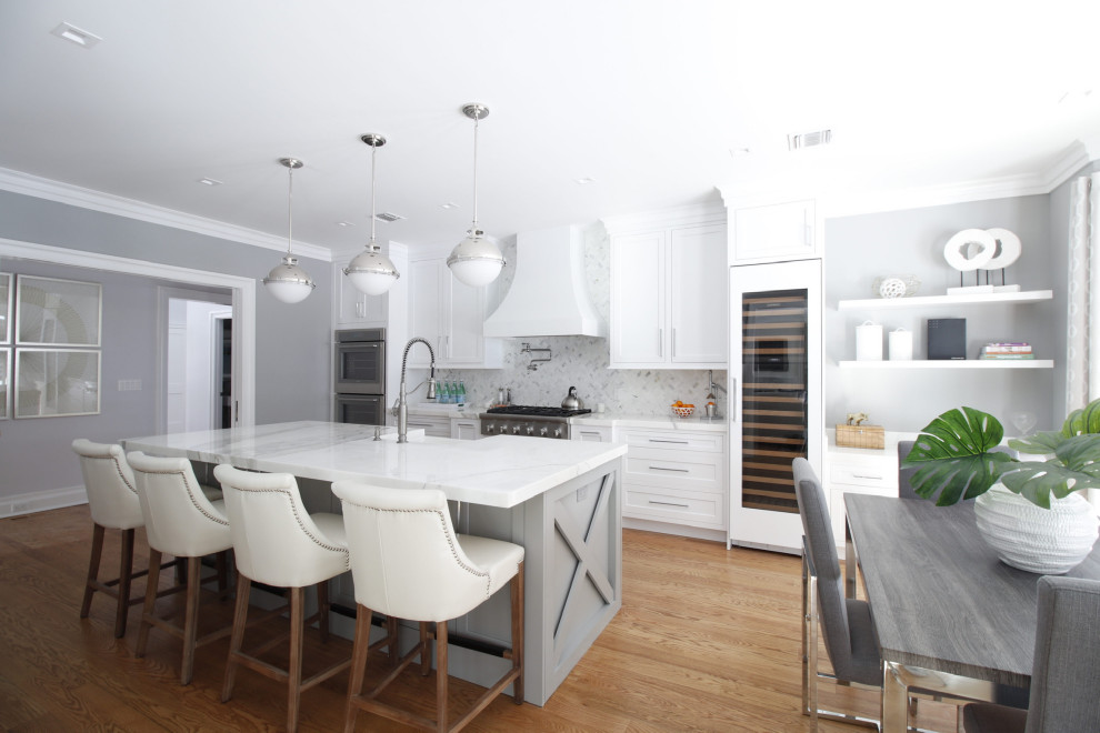 This is an example of a mid-sized transitional galley eat-in kitchen in Charlotte with a farmhouse sink, recessed-panel cabinets, grey cabinets, quartz benchtops, grey splashback, ceramic splashback, stainless steel appliances, light hardwood floors, with island, orange floor and white benchtop.