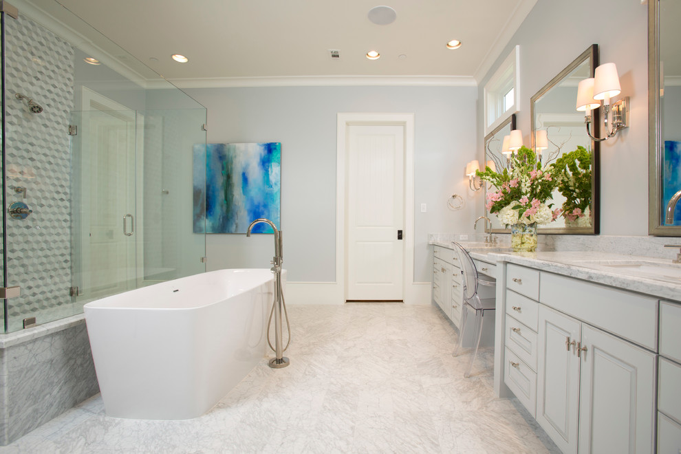 Photo of a large contemporary master bathroom in Houston with raised-panel cabinets, white cabinets, a freestanding tub, a curbless shower, gray tile, white tile, mosaic tile, blue walls, marble floors, an undermount sink and marble benchtops.
