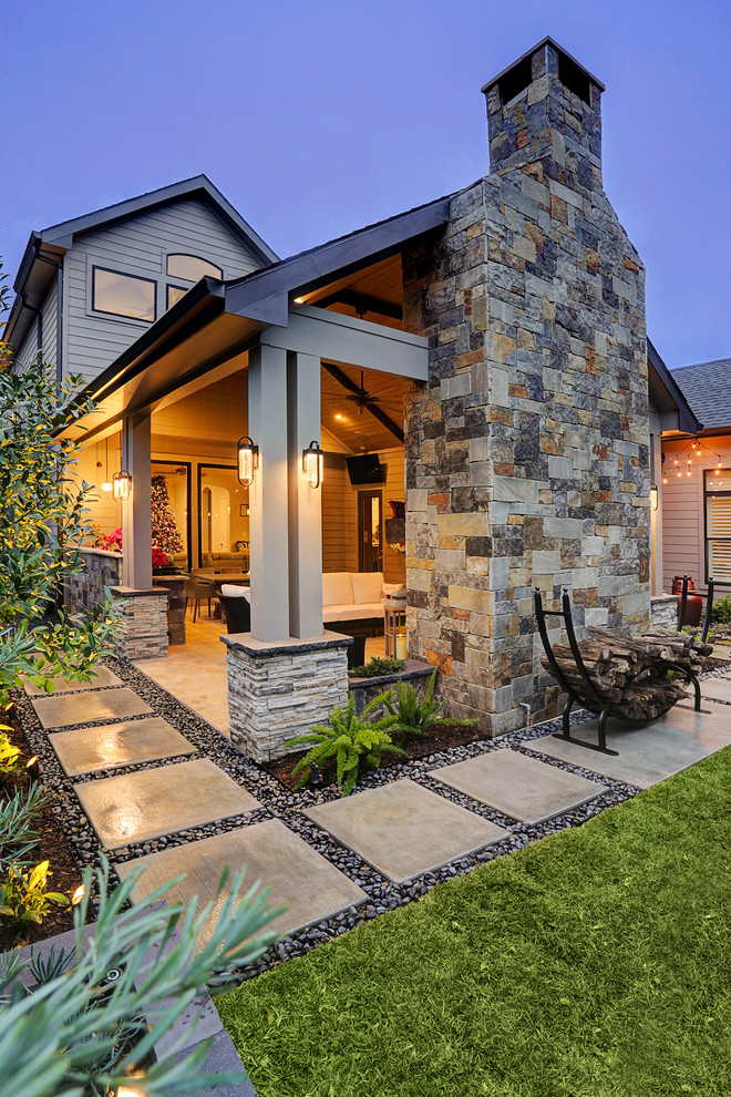 Mid-sized contemporary backyard patio in Houston with an outdoor kitchen, natural stone pavers and a roof extension.