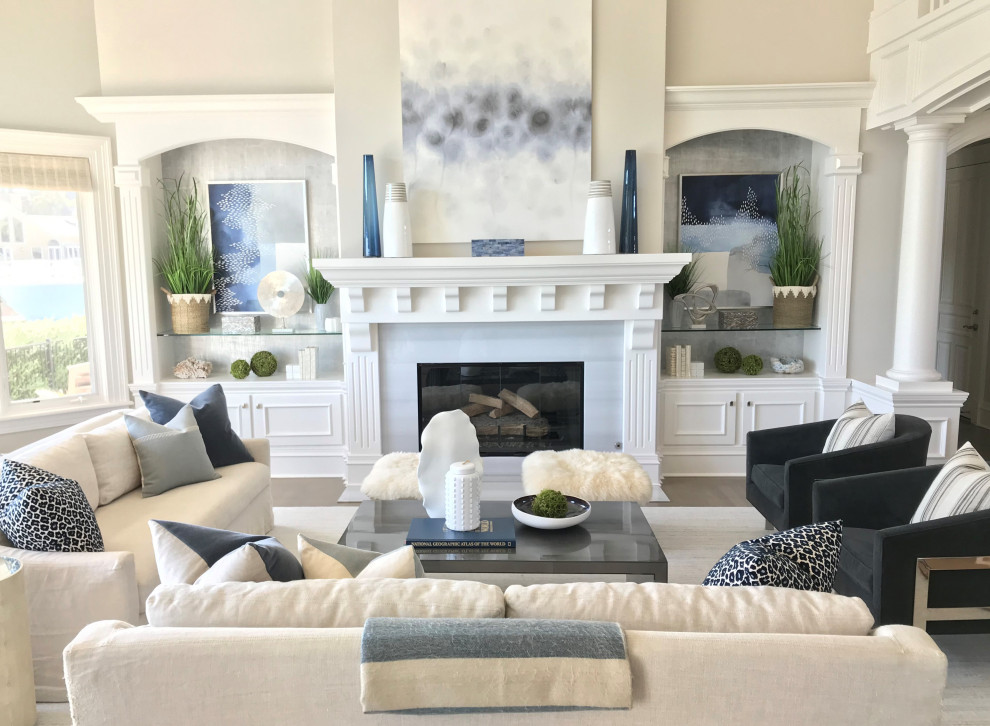 Inspiration for a large beach style formal open concept living room in Sacramento with grey walls, medium hardwood floors, a standard fireplace, a wood fireplace surround, no tv, grey floor, vaulted and wallpaper.