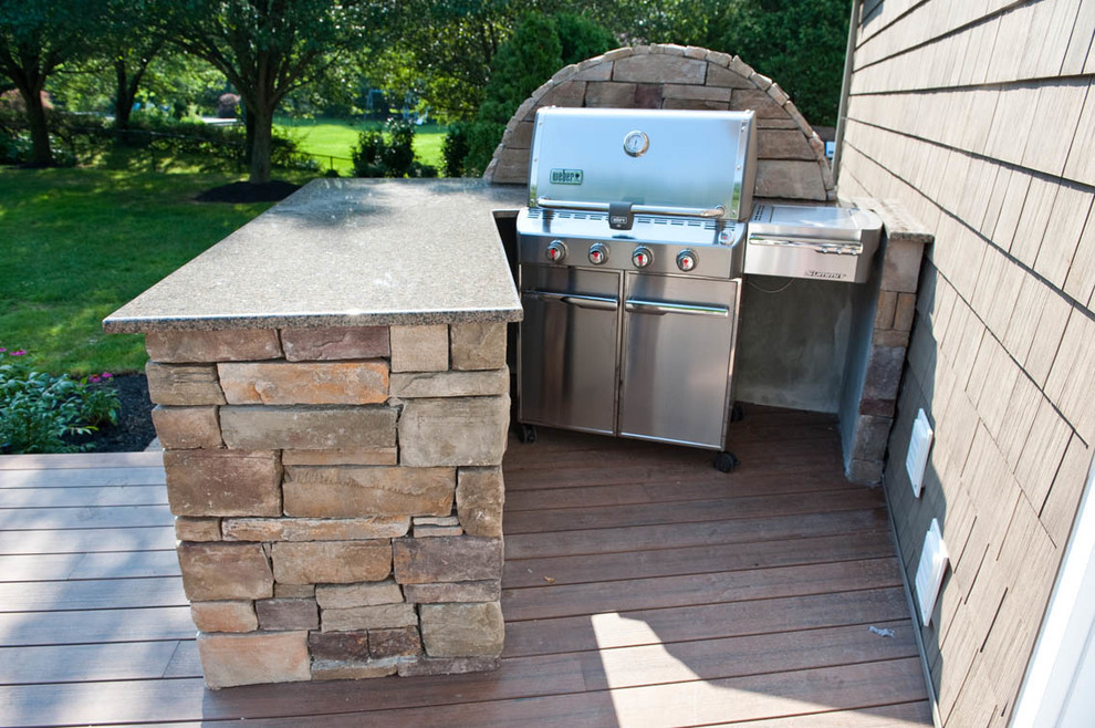 Photo of a large contemporary backyard deck in New York with an outdoor kitchen and no cover.