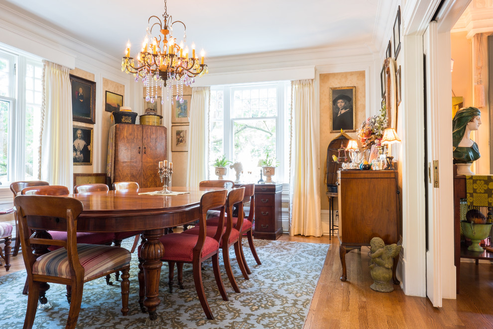 Inspiration for a traditional dining room in Vancouver with beige walls, medium hardwood floors and brown floor.