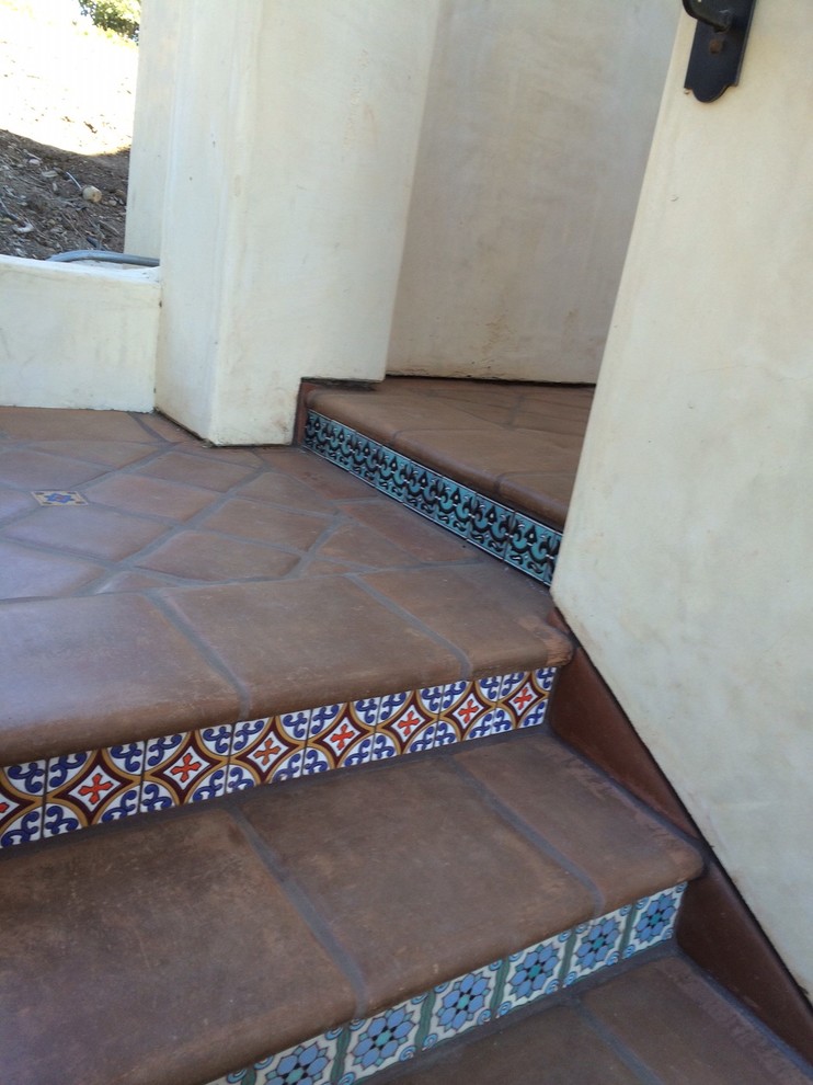 Photo of a country straight staircase in Los Angeles with tile risers.