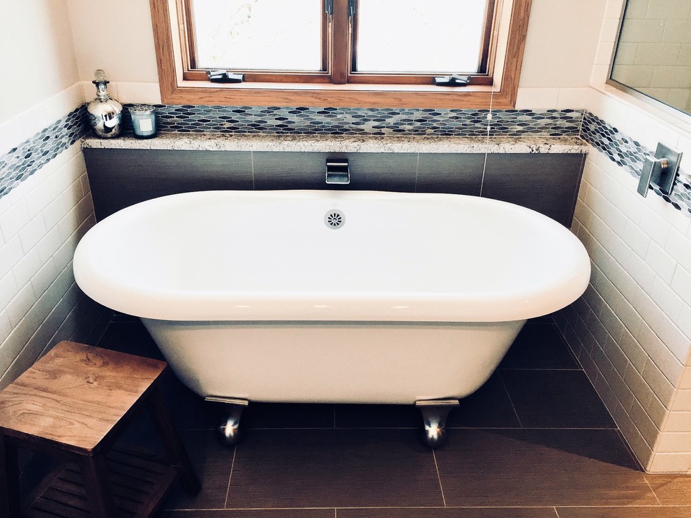 Freestanding bathtub - transitional master multicolored tile and mosaic tile porcelain tile and brown floor freestanding bathtub idea with shaker cabinets, white cabinets, a vessel sink, quartz countertops, a hinged shower door and multicolored countertops