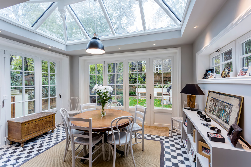 This is an example of a traditional sunroom in London with no fireplace, a glass ceiling and multi-coloured floor.