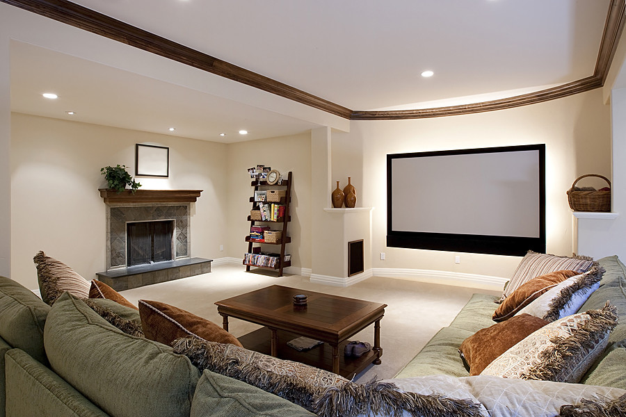 Photo of a large traditional fully buried basement in New York with white walls, carpet, a standard fireplace, a tile fireplace surround and white floor.