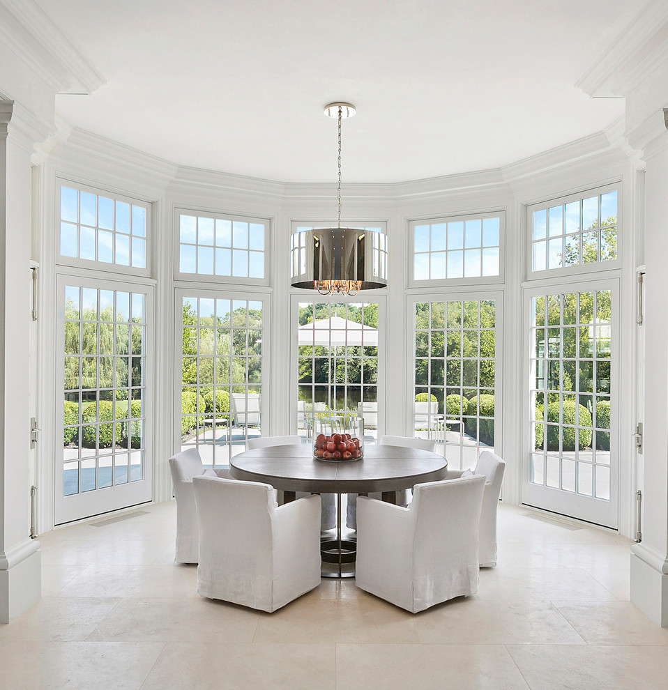 Inspiration for a transitional dining room in New York with white walls and beige floor.