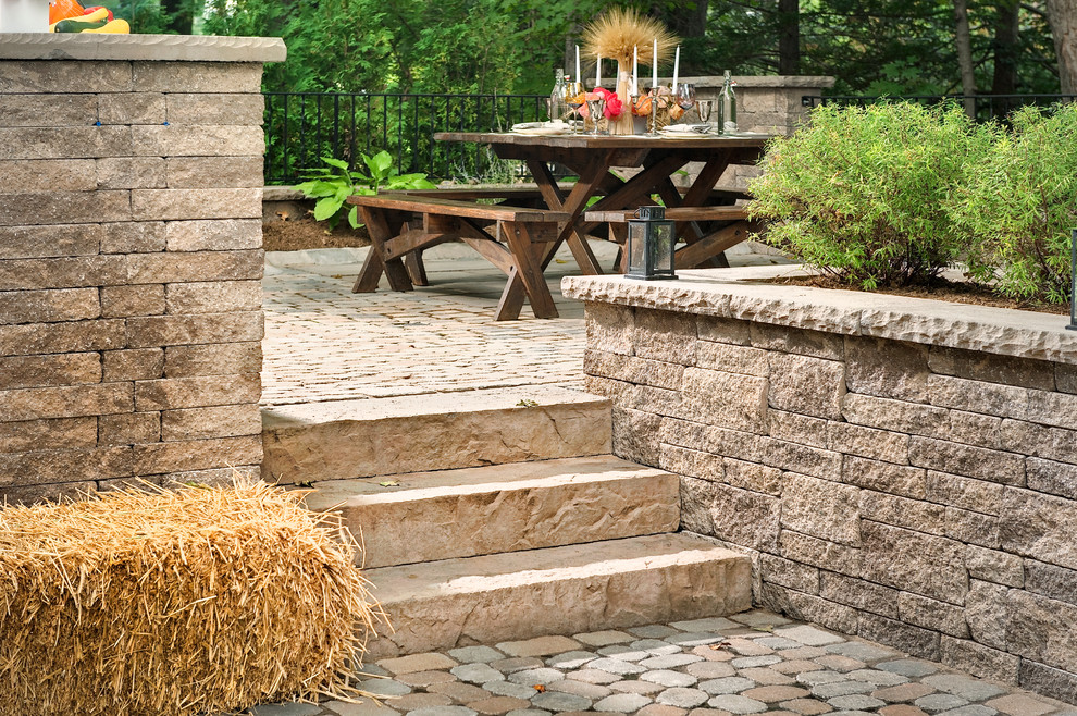 Inspiration for a mid-sized rustic backyard retaining wall landscape.