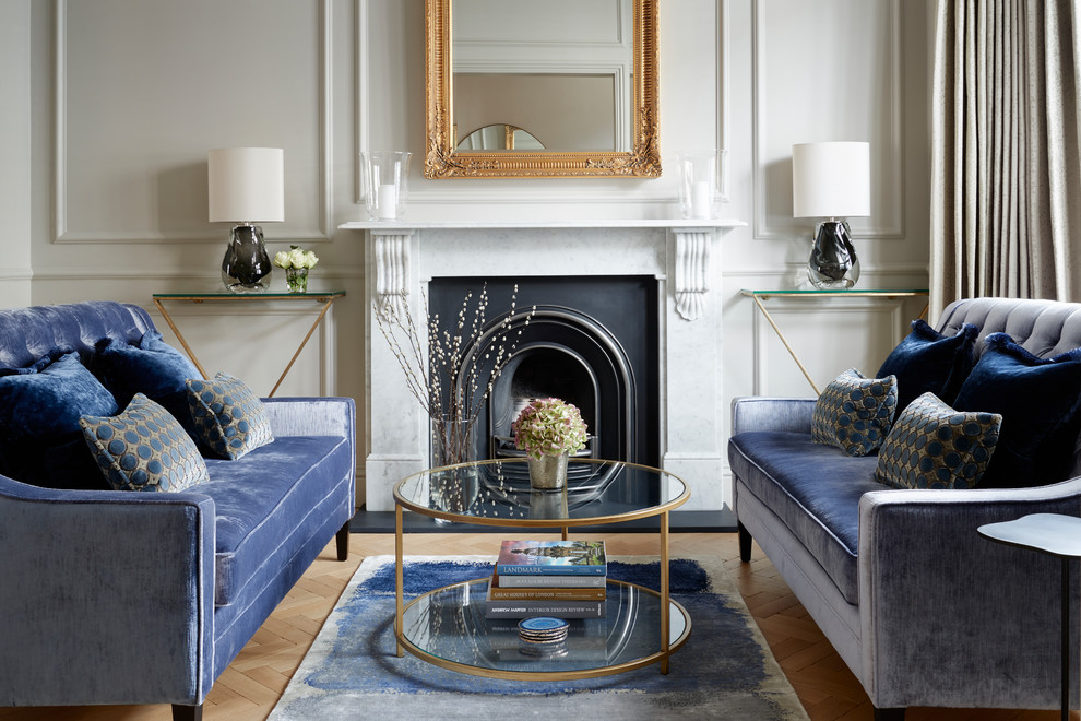 This is an example of a mid-sized traditional formal living room in London with light hardwood floors, a standard fireplace, no tv, white walls and beige floor.