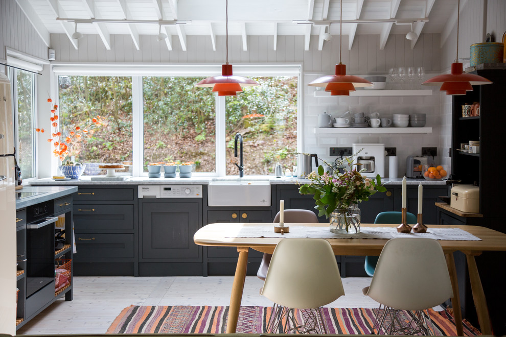 Inspiration for a mid-sized country kitchen/dining combo in London with white walls.