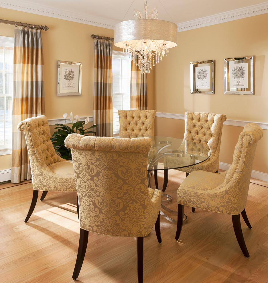 Mid-sized transitional separate dining room in Boston with yellow walls, light hardwood floors and no fireplace.