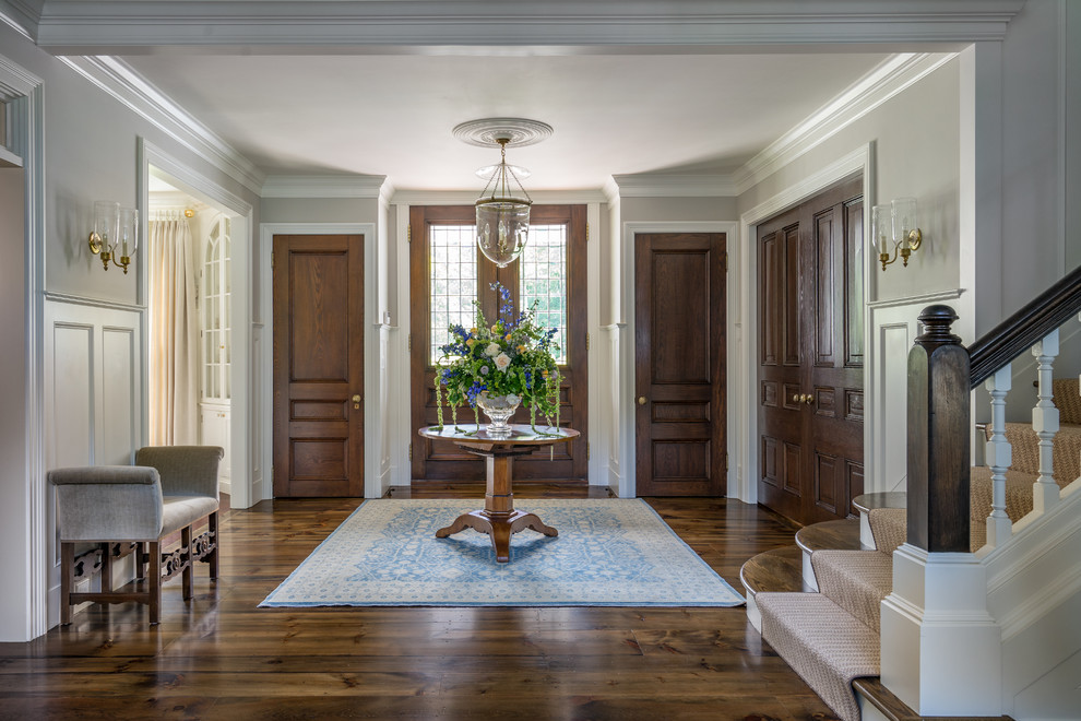 Foyer - traditional dark wood floor foyer idea in Boston with gray walls and a glass front door