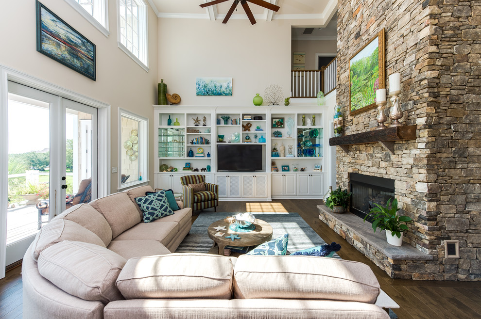 Design ideas for a transitional enclosed family room in Other with beige walls, dark hardwood floors, a standard fireplace, a stone fireplace surround and a built-in media wall.