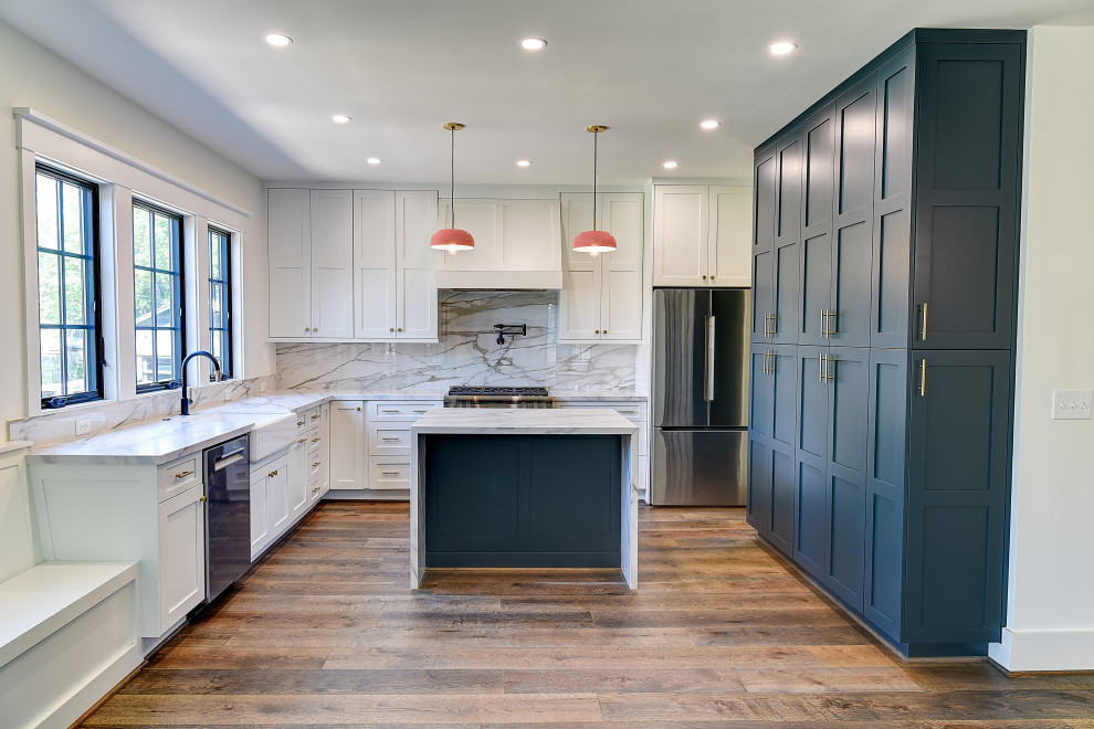 Transitional l-shaped kitchen photo with white cabinets and an island