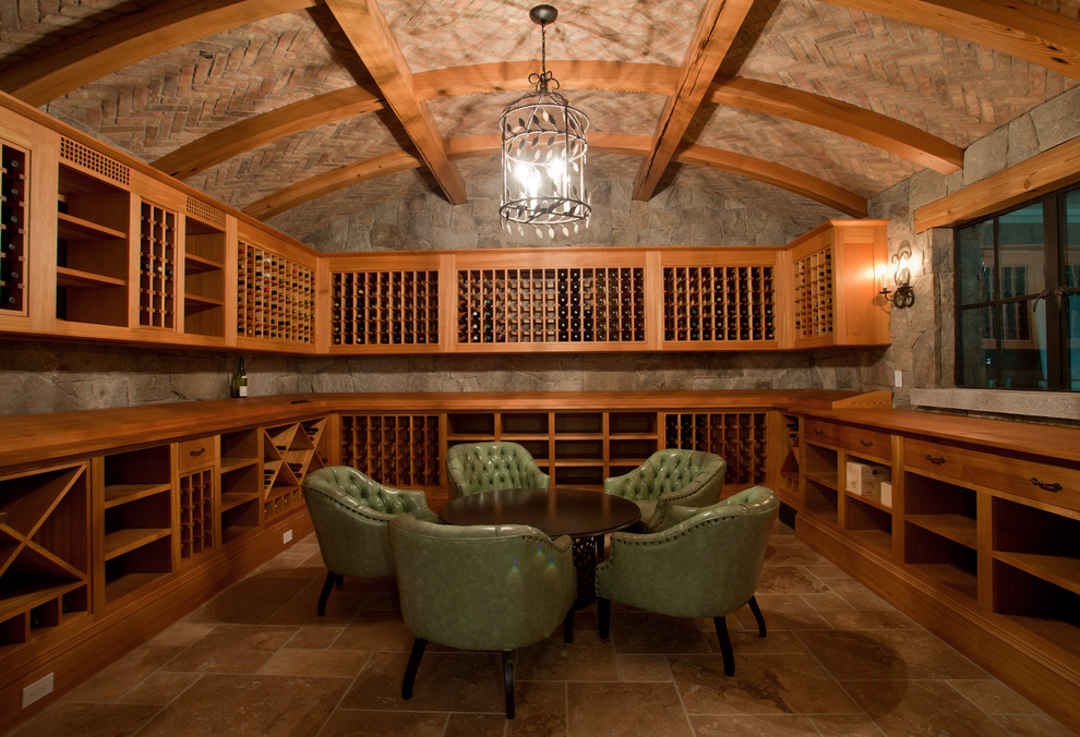 Inspiration for an expansive beach style wine cellar in Providence with display racks, travertine floors and beige floor.