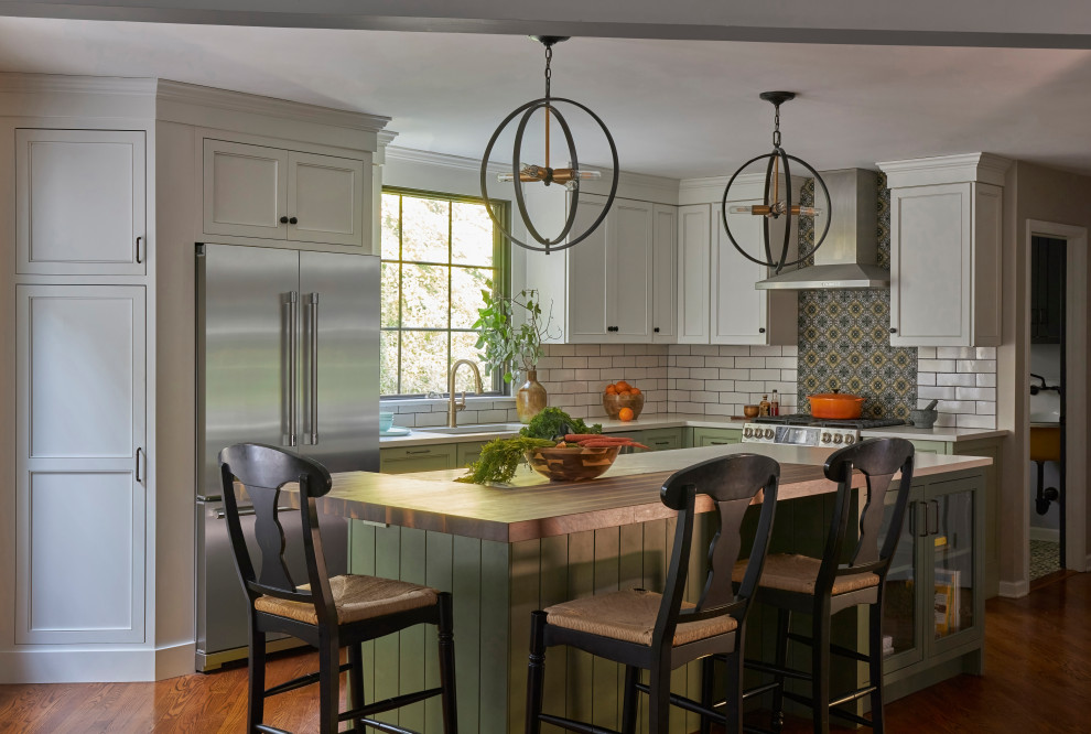 Mid-sized country l-shaped dark wood floor and brown floor eat-in kitchen photo in New York with recessed-panel cabinets, green cabinets, quartz countertops, an island, an undermount sink, white backsplash, subway tile backsplash, stainless steel appliances and white countertops