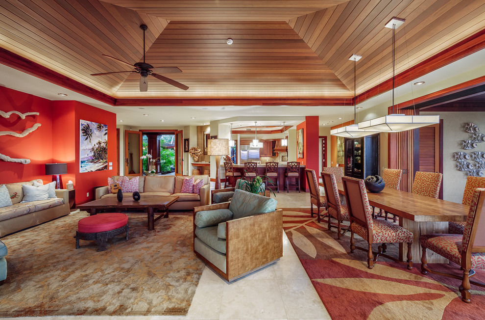 Design ideas for a large tropical open concept living room in Hawaii with a home bar, orange walls, travertine floors and a wall-mounted tv.