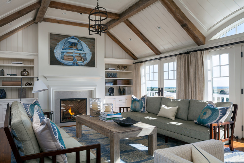 Inspiration for a large beach style formal open concept living room in Boston with a standard fireplace, white walls, medium hardwood floors and a concrete fireplace surround.