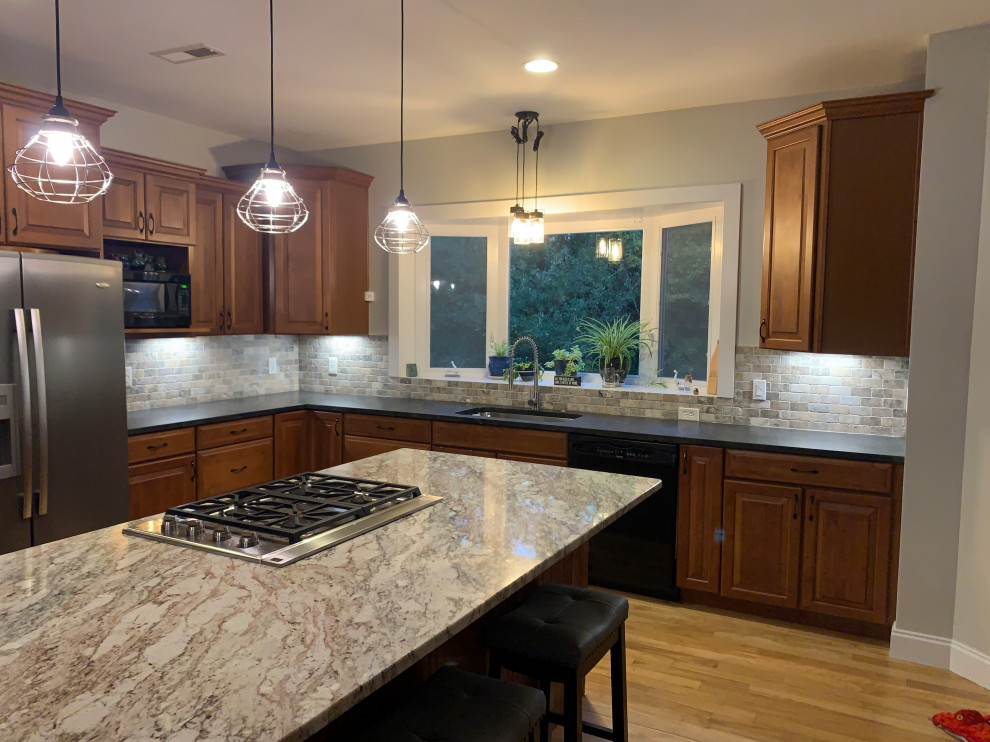 Inspiration for an u-shaped ceramic tile and gray floor open concept kitchen remodel with medium tone wood cabinets, granite countertops, gray backsplash, stone tile backsplash, stainless steel appliances, an island and gray countertops