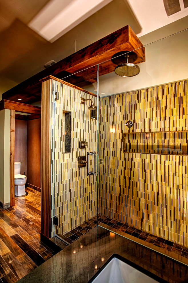 Inspiration for a large contemporary master bathroom in Other with a two-piece toilet, beige tile, black tile, brown tile, multi-coloured tile, yellow tile, matchstick tile, beige walls, porcelain floors, an undermount sink, brown floor and a hinged shower door.