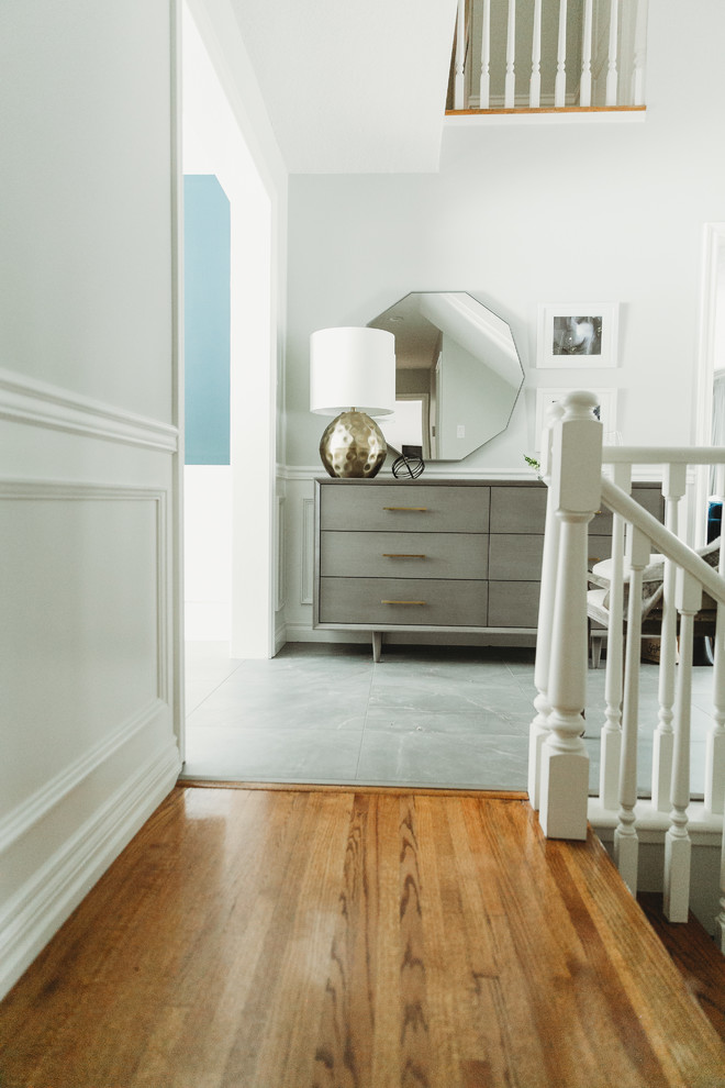 Inspiration for a transitional porcelain tile and gray floor entryway remodel in Calgary