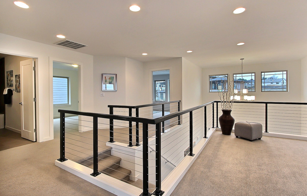 Example of a large transitional carpeted hallway design in Seattle with white walls