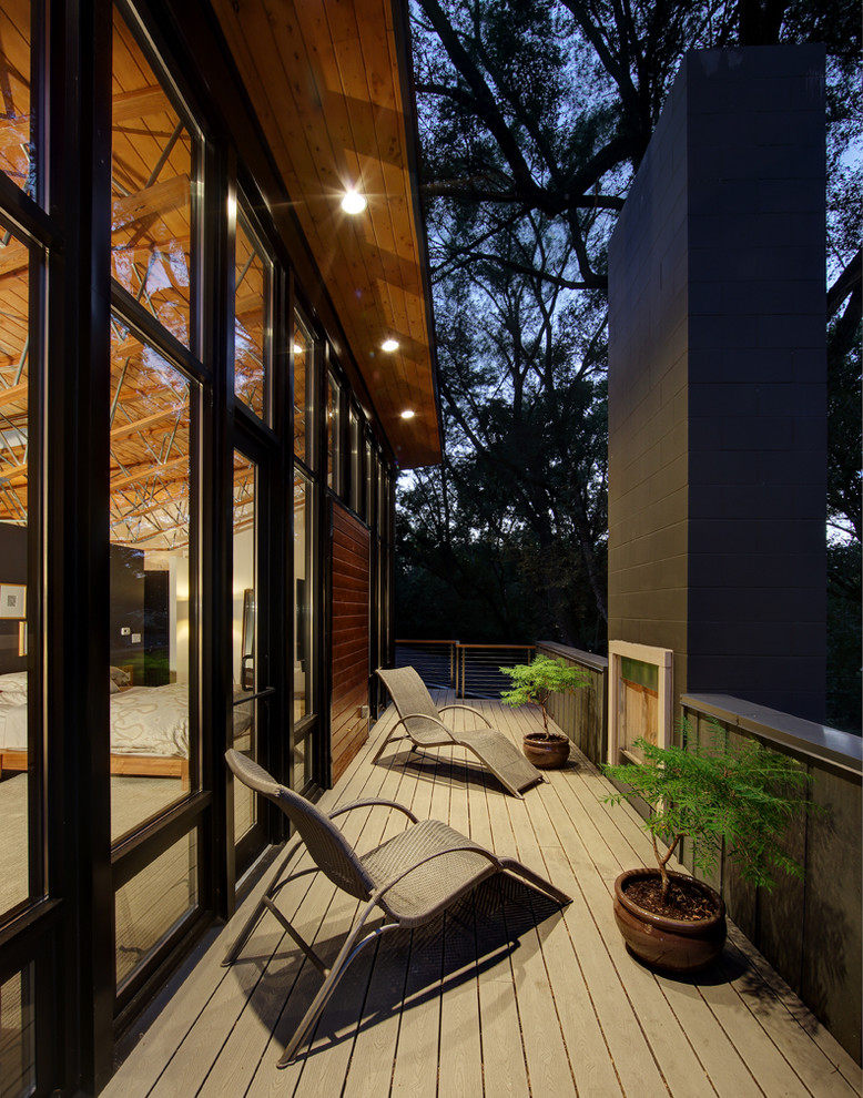 Inspiration for a mid-sized contemporary side yard deck in Milwaukee with a fire feature and a roof extension.