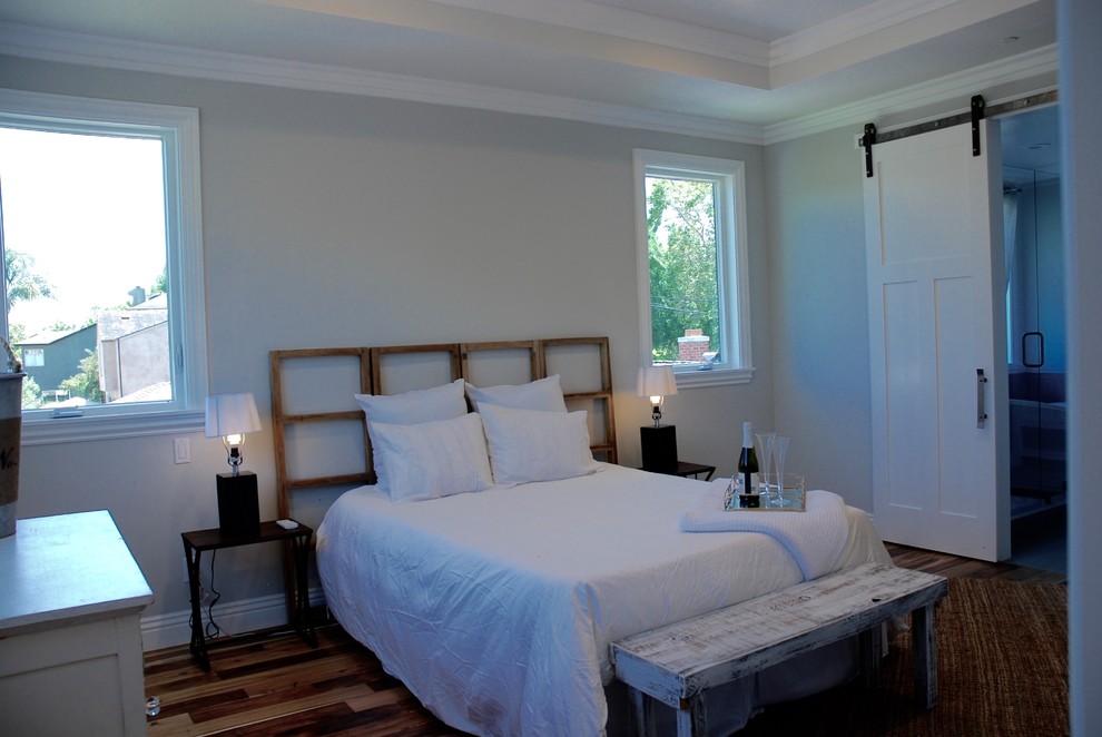 Inspiration for a large country master bedroom in San Francisco with grey walls, medium hardwood floors and brown floor.