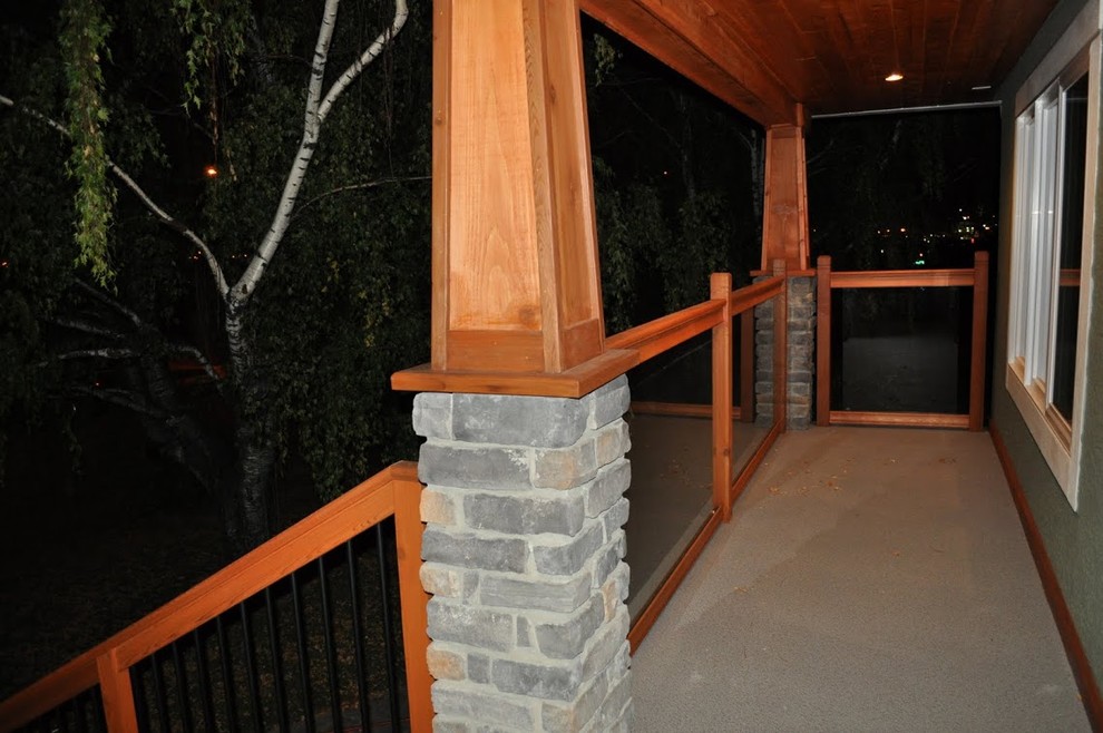 Mid-sized arts and crafts front yard verandah in Calgary with a roof extension.