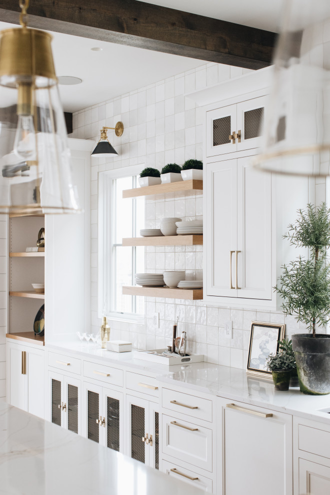 Kitchen - Kitchen - large coastal l-shaped light wood floor and exposed beam kitchen idea in Grand Rapids with white cabinets, quartzite countertops, white backsplash, ceramic backsplash, stainless steel appliances, an island and white countertops