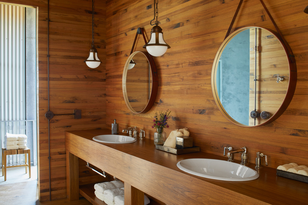Inspiration for a country bathroom in San Francisco with open cabinets, medium wood cabinets, brown walls, medium hardwood floors, a drop-in sink, wood benchtops, brown floor and brown benchtops.
