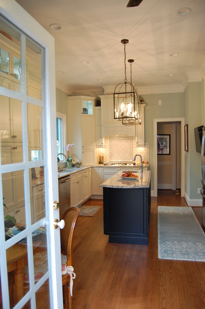 Inspiration for a transitional u-shaped eat-in kitchen remodel in Raleigh with an undermount sink, recessed-panel cabinets, white cabinets, quartzite countertops, white backsplash, subway tile backsplash and stainless steel appliances