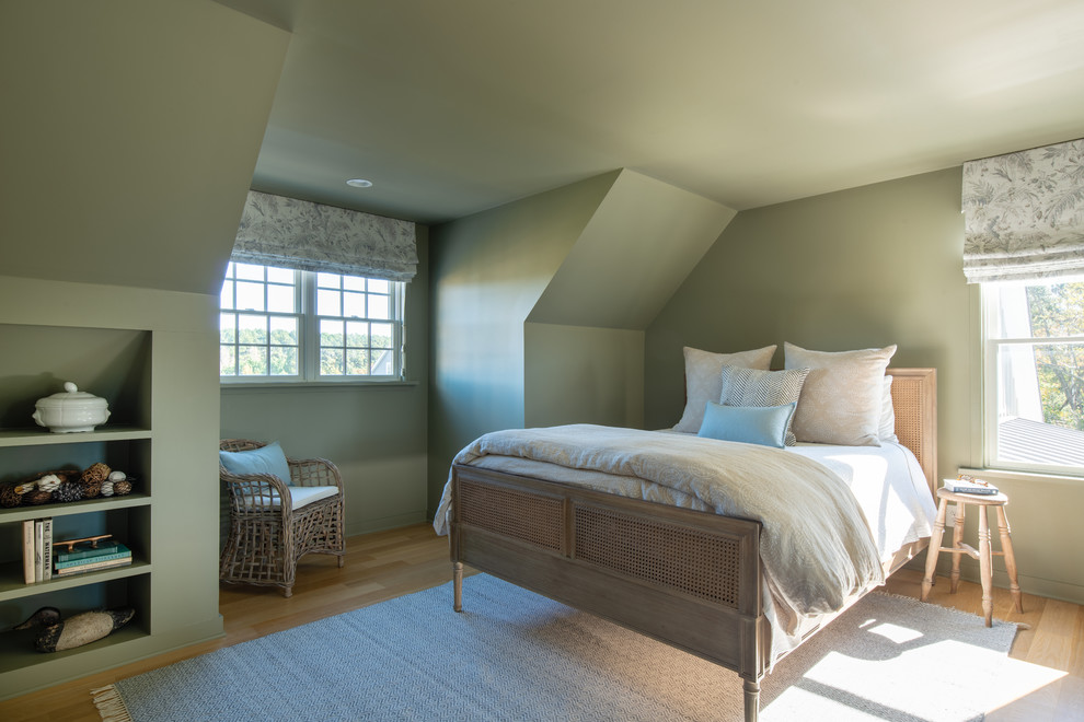 This is an example of a mid-sized country guest bedroom in DC Metro with green walls, medium hardwood floors and brown floor.