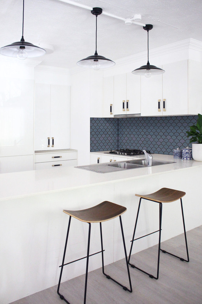 Design ideas for a mid-sized midcentury u-shaped kitchen in Brisbane with a double-bowl sink, white cabinets, quartzite benchtops, blue splashback, ceramic splashback, light hardwood floors, grey floor and white benchtop.