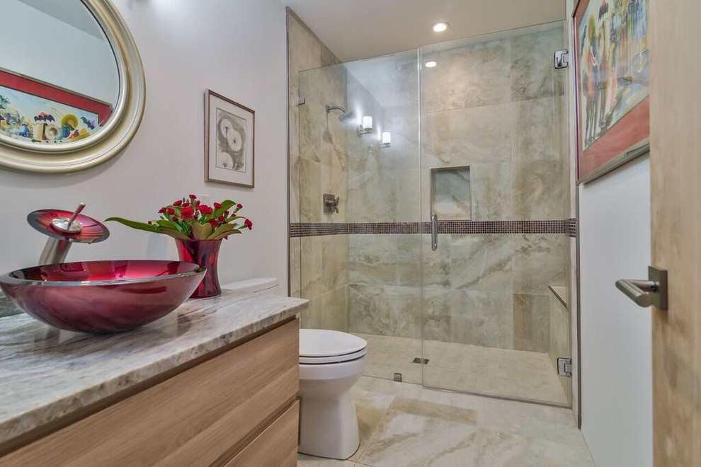 Mid-sized contemporary 3/4 bathroom in Other with flat-panel cabinets, light wood cabinets, an alcove shower, a two-piece toilet, white walls, porcelain floors, a vessel sink, granite benchtops, beige floor and a hinged shower door.