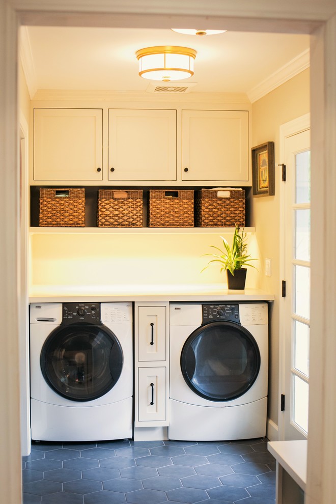 Small country single-wall laundry room in San Francisco with multi-coloured splashback, glass sheet splashback, shaker cabinets, white cabinets, a side-by-side washer and dryer, quartzite benchtops, beige walls, slate floors and black floor.