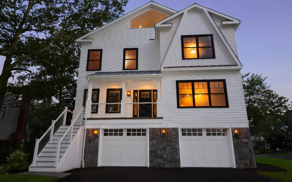 Photo of a large country three-storey white house exterior in Bridgeport with wood siding, a gable roof and a shingle roof.