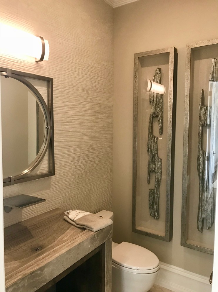Photo of a mid-sized contemporary powder room in Other with recessed-panel cabinets, brown cabinets, a one-piece toilet, multi-coloured tile, beige walls, ceramic floors, a trough sink and beige floor.