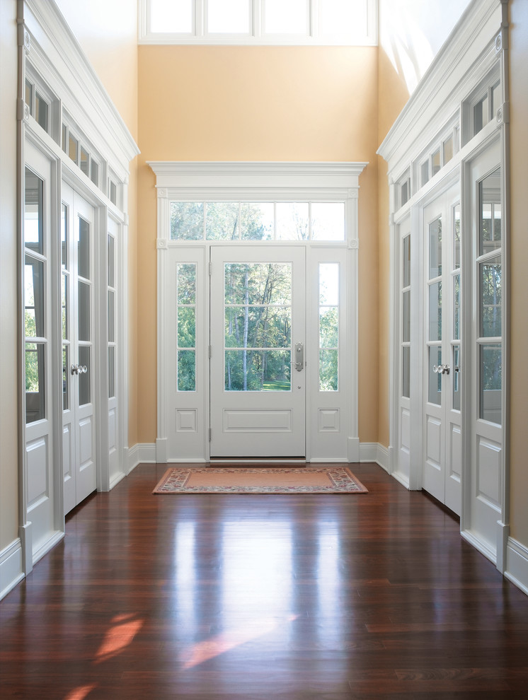 Design ideas for a large traditional entryway in Baltimore with yellow walls, medium hardwood floors and a single front door.