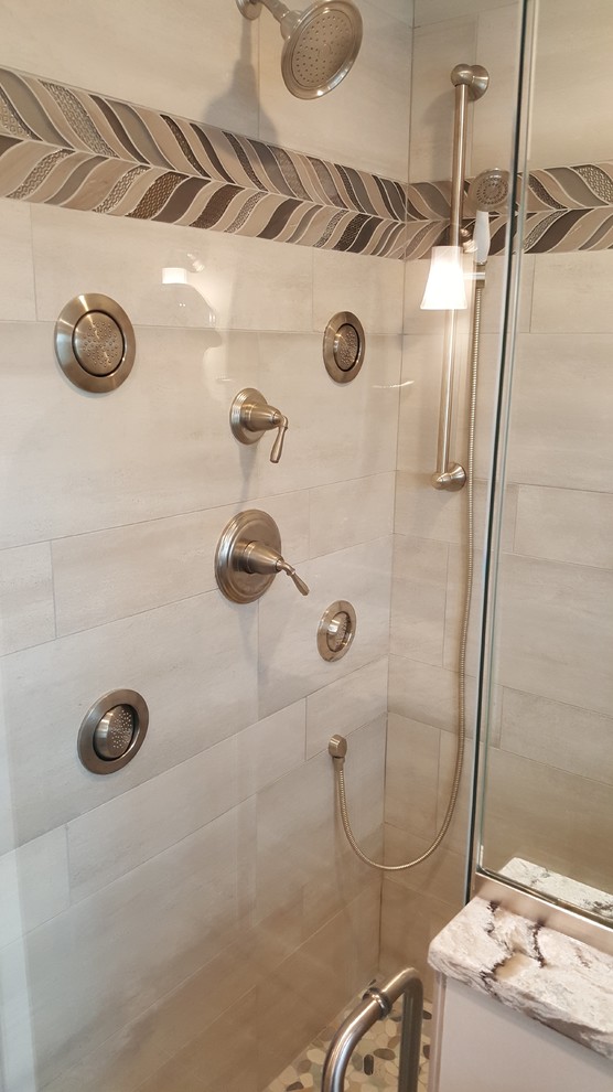Photo of a large modern master bathroom in Bridgeport with raised-panel cabinets, green cabinets, an alcove shower, porcelain floors, an undermount sink, engineered quartz benchtops, brown floor, a hinged shower door and multi-coloured benchtops.