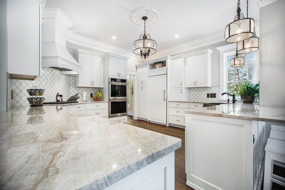 Example of an ornate eat-in kitchen design in Grand Rapids with white cabinets and granite countertops