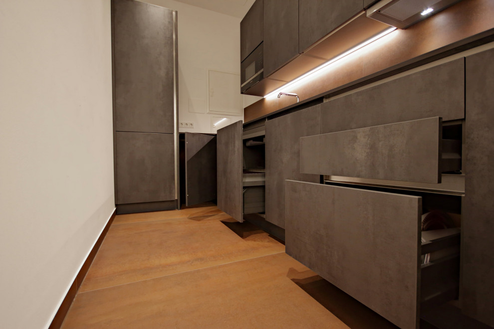 Inspiration for a mid-sized contemporary l-shaped separate kitchen in Munich with a single-bowl sink, flat-panel cabinets, grey cabinets, solid surface benchtops, brown splashback, stone tile splashback, panelled appliances, no island, brown floor and grey benchtop.