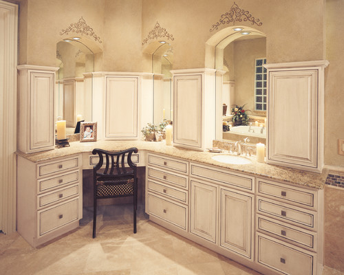 Stencils above each mirror resemble tiaras in this traditionally feminine dressing room, part of a large primary bathroom.