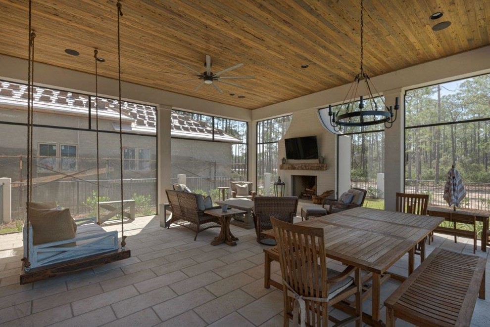 Expansive country sunroom in Miami with limestone floors, a standard fireplace, a standard ceiling, beige floor and a brick fireplace surround.